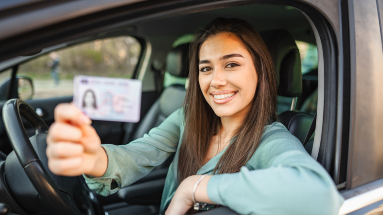 A girl holding her dirver's license.